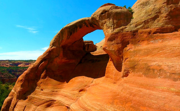 Bright Red Sandstone Arch Against Blue Sky - Rattlesnake Arches In Colorado, USA