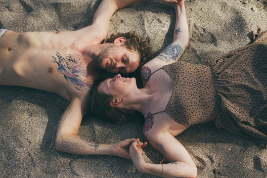 Love couple lying on the beach