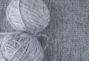 gray wool close-up on a knitted cloth background