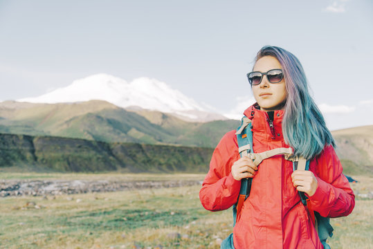 Hiker woman on background of Elbrus mountain.