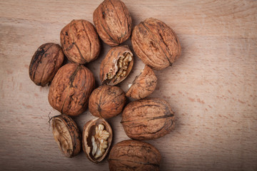 Walnuts (Juglans regia) on a wooden table