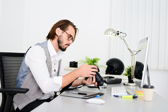 male photographer editing photography in office with a computer, camera and graphic tablet
