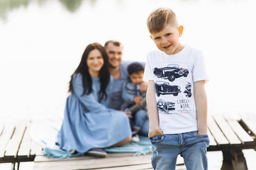 family dad mom and children near the river