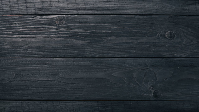 Wooden black texture background. Top view. Free space for your text.