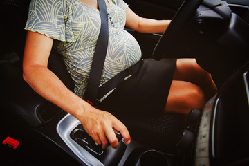 pregnant woman driving a car
