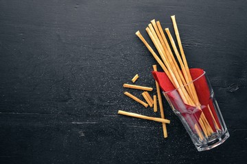 Salt sticks, snack for beer. On a wooden background. Top view. Free space for your text.