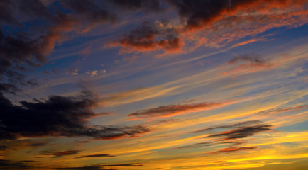 Photo of orange sunset with dark clouds on sky