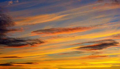 Photo of orange sunset with dark clouds on sky