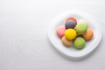 Colorful macarons cakes. On a wooden background. Top view. Free space for your text.