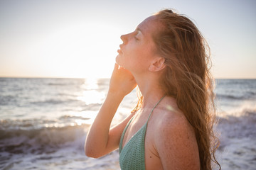 Fototapeta na wymiar young slim beautiful woman on sunset beach, happy, photo toned