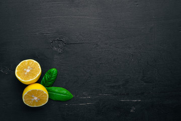 Fresh lemons. On a wooden background. Top view. Free space for your text.