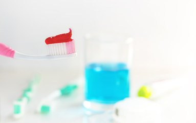 Toothbrush, mouthwash and toothpaste on white background