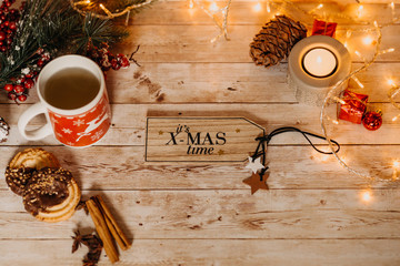 top view of Christmas and new year decorations on wooden desk with ´it´s x-mas time` written on it