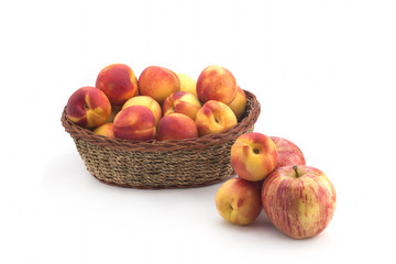 Apricots in a basket of straw on a white background