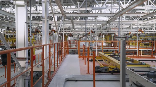 Automobile plant, new car body moves along the conveyor, modern production of cars, automated production line.
