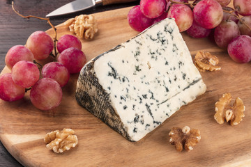 Blue cheese closeup with grapes and nuts