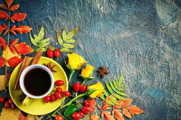 Dark autumn background with Cup of coffee and autumn leaves.