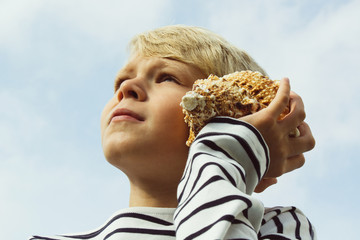 Child listen to seashell