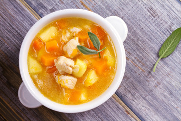 Chicken, butternut, apple ginger and sage stew. Pumpkin and chicken breast soup. View from above, top shot, horizontal