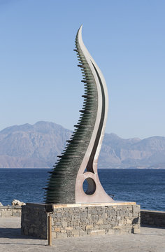 Port of Agios Nikolaos, Crete, Greece. The Amalthea's Horn sculpture on the seafront
