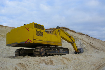 old abandoned yellow excavator in sandpit