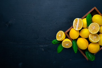 Fresh lemons. On a wooden background. Top view. Free space for your text.