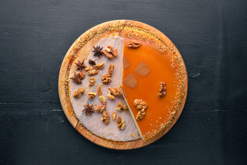 Nutcake. On a wooden background. Top view. Free space for your text.