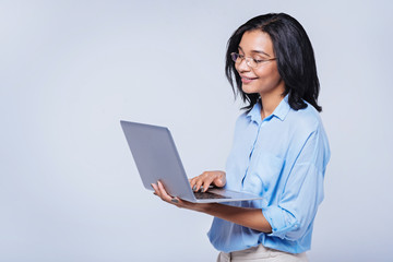 Charming smiling woman working on laptop