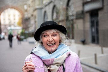 Excited senior lady laughing outdoor