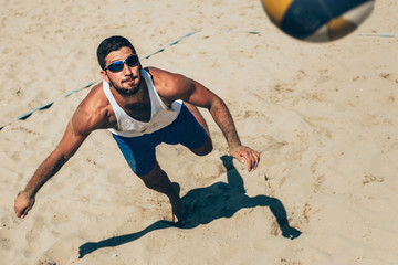 Beach volleyball Player about to hit the ball