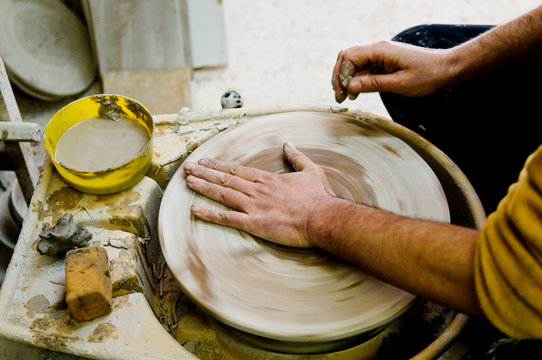 Hands in a potter's wheel
