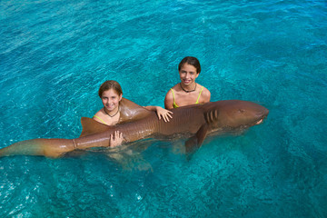 Sister girls hug a Nurse Shark in Riviera Maya