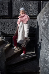 Confident old lady on steps of architectural landmark