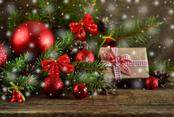 Happy New Year - a holiday background with fir, balls, cones on the wooden background