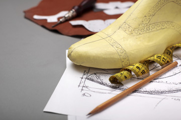 Modelling design of a shoes.Workplace of shoe designer Selective focus.Copy space.