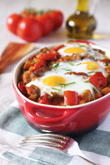 Ratatouille with baked eggs and olive oil 