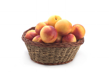 Nectarines in a basket on a white background