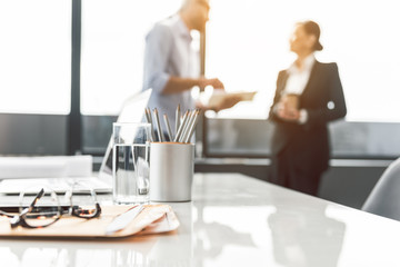 Colleagues having conversation in office