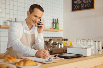 Positive nice man talking on the phone