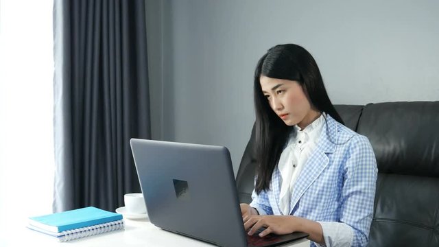 4k of young Asian Business woman working on laptop computer in office.