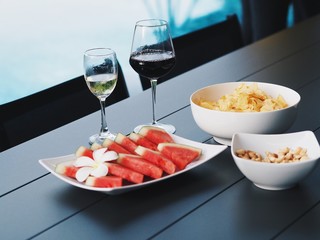 watermelon and snack and drink on pool background,pool party concept.