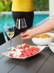 watermelon and snack and drink on pool background,pool party concept.