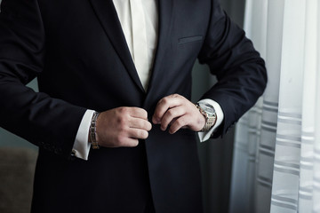 Businessman wears a jacket.Politician, man's style,male hands closeup, American, European businessman, business, fashion and clothing concept