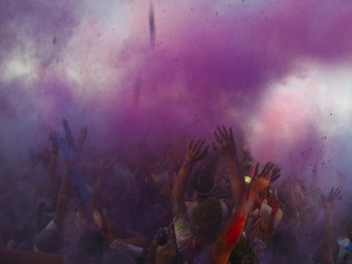 Crowd throwing holi powder in the air