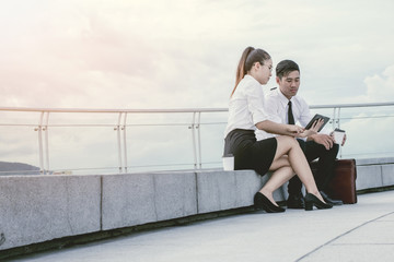 businessman and woman using tablet of working. Meetings the commercial activities in promoting. Together create a mutually beneficial on terrace.outside