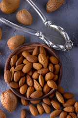 Almonds nuts on bowl with nutcracker