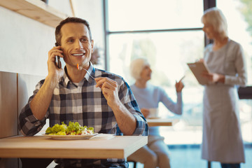 Smart happy man enjoying his food