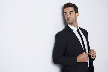 Businessman looking away in white studio