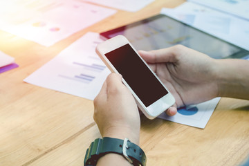 Close up of men hands holding touching mobile phone with blank copy space for your text message on table,Vintage tone.Selective focus