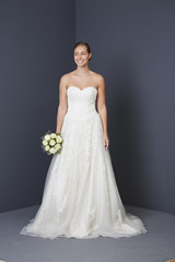 Fototapeta na wymiar Stunning bride in white wedding dress, smiling